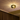 Flush mount chandelier ceiling light softly lighting up dining area during nighttime.