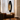 Elegant wooden floor lamp illuminating warm tones in a classic bedroom setting