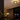 Modern flush mount chandelier paired with ambient pendant lighting casts warm light reflections for a tranquil holiday night setting in the living space.